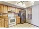 Kitchen with wood cabinets, stainless steel appliances, and vinyl flooring at 6316 Spoonbill Dr, New Port Richey, FL 34652