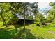 Ranch-style home with screened porch and lush landscaping at 11621 Colt Way, Hudson, FL 34669