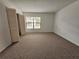 Bright bedroom with neutral carpeting and large closet at 6592 Brambleleaf Dr, Spring Hill, FL 34606