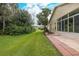 Spacious backyard with grassy area and paver patio at 1153 Dustan Pl, Trinity, FL 34655