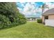 Backyard view with pond, lush vegetation, and white fence at 1153 Dustan Pl, Trinity, FL 34655