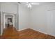 Bedroom with wood flooring, access to living room and ceiling fan at 1153 Dustan Pl, Trinity, FL 34655