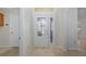 Bright entryway with a glass front door and beige tile flooring at 1153 Dustan Pl, Trinity, FL 34655