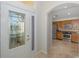 View of entryway and kitchen with wood cabinets and stainless steel appliances at 1153 Dustan Pl, Trinity, FL 34655