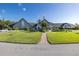 Community clubhouse with manicured lawn and flag at 1153 Dustan Pl, Trinity, FL 34655
