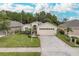Single-Gathering home with attached garage and manicured lawn at 1153 Dustan Pl, Trinity, FL 34655