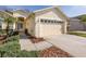 House exterior showcasing a walkway to the front door and garage at 1153 Dustan Pl, Trinity, FL 34655
