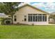 Tan house exterior with a large glass enclosure at 1153 Dustan Pl, Trinity, FL 34655