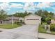 Beige house exterior with two car garage at 1153 Dustan Pl, Trinity, FL 34655