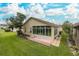 House exterior showcasing sunroom and backyard at 1153 Dustan Pl, Trinity, FL 34655