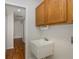 Laundry room with wooden cabinets and utility sink at 1153 Dustan Pl, Trinity, FL 34655