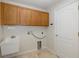 Laundry room with wooden cabinets and utility sink at 1153 Dustan Pl, Trinity, FL 34655