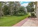 Red brick paver patio bordered by green lawn and trees at 1153 Dustan Pl, Trinity, FL 34655