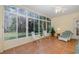 Sunroom with tiled floor, wicker furniture, and large windows at 1153 Dustan Pl, Trinity, FL 34655