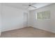 Bright bedroom with carpet flooring, ceiling fan, and window blinds at 9410 Fox Hollow Ln, Weeki Wachee, FL 34613