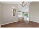 Spacious dining area with wood floors and a chandelier at 9410 Fox Hollow Ln, Weeki Wachee, FL 34613