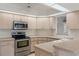 Modern kitchen with stainless steel appliances and ample counter space at 9410 Fox Hollow Ln, Weeki Wachee, FL 34613