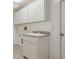 Laundry room with cabinets and countertop sink at 9410 Fox Hollow Ln, Weeki Wachee, FL 34613