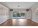 Open living space with wood floors and sliding doors to the pool at 9410 Fox Hollow Ln, Weeki Wachee, FL 34613