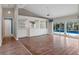 Bright living room features wood floors, pool view, and built-in shelving at 9410 Fox Hollow Ln, Weeki Wachee, FL 34613