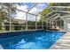 Inviting screened pool with lounge chairs at 9410 Fox Hollow Ln, Weeki Wachee, FL 34613