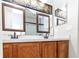 Bathroom showcasing a double vanity, decorative mirrors, modern fixtures, and a neutral color scheme at 2529 Sandy Hill Ct, Holiday, FL 34691