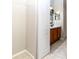 Bathroom and walk-in closet with vanity cabinet, offering convenience and ample storage at 2529 Sandy Hill Ct, Holiday, FL 34691