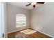 Cozy bedroom with hardwood floors, a window providing natural light, and neutral-colored walls at 2529 Sandy Hill Ct, Holiday, FL 34691