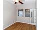 Comfortable bedroom with hardwood floors, a ceiling fan, and french doors leading to another room at 2529 Sandy Hill Ct, Holiday, FL 34691