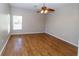 Inviting bedroom with natural light, featuring hardwood floors and a modern ceiling fan at 2529 Sandy Hill Ct, Holiday, FL 34691