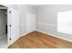 Bedroom featuring wood-look floors, closet, and neutral walls at 2529 Sandy Hill Ct, Holiday, FL 34691