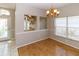 Dining area showcasing hardwood floors, decorative glass panels, and a chandelier at 2529 Sandy Hill Ct, Holiday, FL 34691
