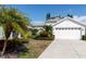 Charming single-story home with a well-manicured lawn and a two-car garage at 2529 Sandy Hill Ct, Holiday, FL 34691