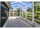 Screened lanai with tile flooring and a view of the lush backyard at 2529 Sandy Hill Ct, Holiday, FL 34691