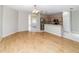 Spacious living room featuring hardwood floors that seamlessly connects to the kitchen with stainless steel appliances at 2529 Sandy Hill Ct, Holiday, FL 34691