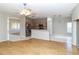 Bright living room with hardwood floors offering a view of an open kitchen with stainless steel appliances at 2529 Sandy Hill Ct, Holiday, FL 34691