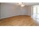 Spacious living room featuring wood-look floors and a ceiling fan with lighting at 2529 Sandy Hill Ct, Holiday, FL 34691