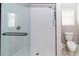 Modern shower with glass enclosure, white tiling, and updated fixtures in the bathroom at 2529 Sandy Hill Ct, Holiday, FL 34691