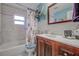 Updated bathroom with a vintage vanity, framed mirror, and sea-themed shower curtain at 3178 Sea Grape Dr, Hernando Beach, FL 34607