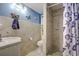 Coastal bathroom with starfish accents, a tiled shower, and modern fixtures at 3178 Sea Grape Dr, Hernando Beach, FL 34607