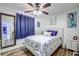 Bright bedroom with beach-themed decor, a cozy bed, and light wood flooring at 3178 Sea Grape Dr, Hernando Beach, FL 34607
