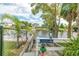 A boat ramp with a dock and railing near the water at 3178 Sea Grape Dr, Hernando Beach, FL 34607