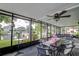 An enclosed porch with a dining table and an outdoor view of the water at 3178 Sea Grape Dr, Hernando Beach, FL 34607