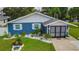 Exterior of a beautiful blue home with well-manicured landscaping at 3178 Sea Grape Dr, Hernando Beach, FL 34607