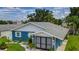 Exterior of a charming blue home with well-manicured landscaping and an attached garage at 3178 Sea Grape Dr, Hernando Beach, FL 34607