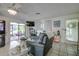 Bright and airy living room with tile floors, large windows, and comfortable seating for relaxing at 3178 Sea Grape Dr, Hernando Beach, FL 34607
