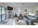Bright living room features tile floors, cozy seating, and sliding glass doors to outdoor space at 3178 Sea Grape Dr, Hernando Beach, FL 34607