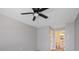 Bright bedroom featuring a ceiling fan and access to bathroom at 4321 Tahitian Gardens Cir # A, Holiday, FL 34691