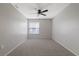Well-lit bedroom featuring neutral walls and carpet at 4321 Tahitian Gardens Cir # A, Holiday, FL 34691