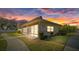 Updated one-story home with landscaped yard at sunset at 4321 Tahitian Gardens Cir # A, Holiday, FL 34691